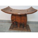 A vintage teak stool in the form of an elephant, on a plinth base. H51 W54 D32 Condition report: