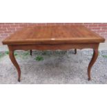 An antique French oak draw-leaf extending dining table of good colour, on cabriole supports. H78