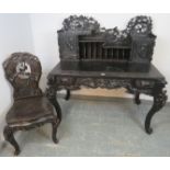 A vintage ebonised writing desk in the 19th century Chinese style, the upper gallery with fitted