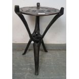 A vintage African tribal occasional table, the reversible top with relief carving depicting wild