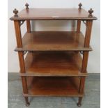 An Edwardian mahogany freestanding four-tier whatnot of small proportions, having turned finials and