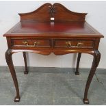 A vintage 19th century style mahogany writing table by Maple & co, with inset burgundy leather