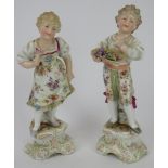 A pair of German Triebner, Ens & Co porcelain figurines of a boy and girl, circa/post 1900. Blue