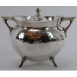 A Mappin & Webb silver plated spot hammered tea caddy designed by Christopher Dresser, late 19th