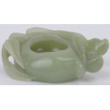 A Chinese pale celadon jade brush washer cup, 20th century. Carved in the form of a simplified lotus