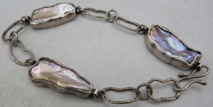 A handmade silver & Baroque pearl bracelet, consisting of three silver cased pearls each approx 25mm