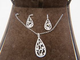 A fine pear shaped 9ct white gold pendant with openwork floral design encrusted with diamonds on a