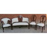 An Edwardian mahogany salon suite comprising a two-seater sofa, tub chair and two side chairs, the
