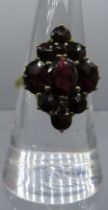 A 9ct yellow gold garnet diamond shaped cluster ring. Centre garnet approx 8cm x 6cm. Size O. 4.4