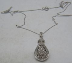 A 9ct white gold pear shaped pendant encrusted with diamonds on a fine white metal chain, clasp