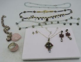 A white metal pendant set with a group of semi-precious stones including garnets, amethyst & topaz