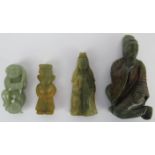 A group of four Chinese celadon and russet jade figural carvings, 20th century. (4 items)