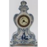 A German Delft style ceramic mantle clock. French brass movement. Identical in style to German