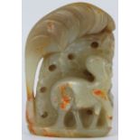 A Chinese pale green and russet jade carving of a deer amongst foliage, 20th century. 9 cm height.