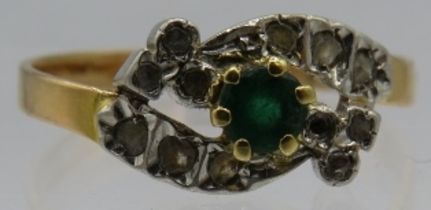A French gold emerald and diamond cross over ring. Size N. 2.4 grams. Condition report: One