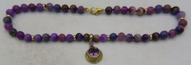 A rare and unusual Russian sugilite bead necklace with yellow metal amethyst pendant. Amethyst