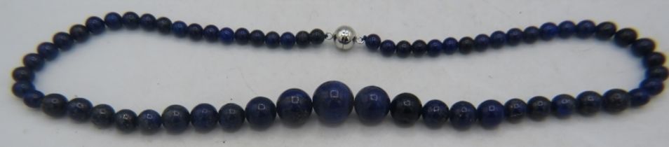 Graduated Lapis Lazuli bead necklace. 19.5" length. Largest polished bead 16mm. Magnetic clasp.