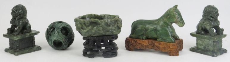 A group of Chinese green jade and hardstone carvings, 20th century. Comparing a recumbant horse on a
