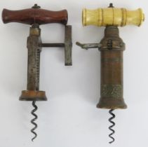 Two Victorian brass and steel corkscrews. One of Lund type design with a turned wood handle together