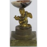 A European ormolu gilt bronze and agate kneeling putti with dove, early 19th century. The putti