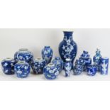 A large group of Chinese blue and white blossoming prunus pattern porcelain ginger jars and vases,