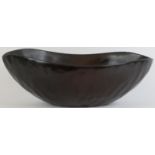 A Caribbean Haitian carved wood bowl crafted to simulate bronze, Haiti, 20th century. Signed