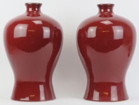 A large pair of Chinese sang de boeuf porcelain vases, 20th century.