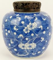A large Chinese blue and white porcelain ginger jar and openwork carved wood cover, 19th century.
