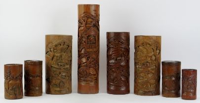 Eight Chinese carved bamboo brush pots and containers, 20th century.