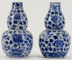 Two Chinese blue and white porcelain double gourd vases, 19th century. Underglaze blue four