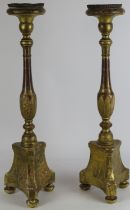 A European Roman Catholic ecclesiastical pair of gilt gesso carved wood altar candlesticks, 19th