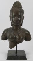 A Cambodian Buddhist bronze bust, 20th century. 36 cm total height. Condition report: Light wear
