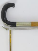 A vintage bamboo and ebony walking cane with integrated horse measuring stick. Incorporated with a