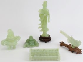 A group of five Chinese celadon jade carvings, 20th century. Comprising a bird modelled on a gnarled