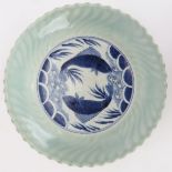 A Japanese Arita blue, white and celadon porcelain dish, 18th century. Painted to the centre in