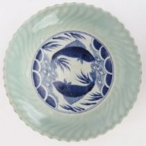 A Japanese Arita blue, white and celadon porcelain dish, 18th century. Painted to the centre in