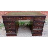 A 19th century style pedestal desk, the top with inset tooled green leather, having a