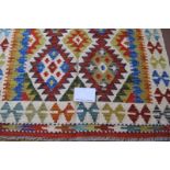A fine Chobi Kilim rug. Good vibrant colours and in excellent condition. 150cm x 101cm.