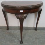 An Edwardian flame mahogany demi-lune folding card table in the George II taste, having inset