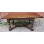 A vintage antique style oak draw-leaf table by Reprodux, on turned supports with block feet united