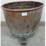 A 19th century copper banded and riveted copper, on scrolled cast iron supports. H39cm Diameter 45cm