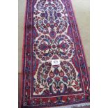 A North West Persian red bar runner, floral central pattern cream on red. 400cm x .83cm. Condition