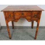 A figured walnut lowboy in the 18th century taste, the quarter veneered top crossbanded and with