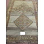 An early-mid 20th century Persian rug, diamond motifs to centre with 3 leaves - edges worn, colour