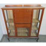 An Edwardian walnut side cabinet strung with satinwood, the fall front central section housing a