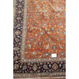 A fine Persian Sarouhn rug with a central block pattern of foliage on salmon pink ground. In good