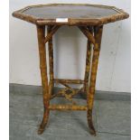 An antique colonial tiger bamboo octagonal two-tier table with painted Chinoiserie decoration, on