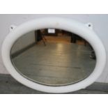 A novelty oval wall mirror, constructed from an antique ship’s cast iron porthole painted white.