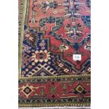 A fine North West Persian Heriz carpet, central design on salmon pink ground, with blue