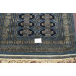 A 20th century Persian blue ground rug with repeat central pattern and in good condition. 128cm x